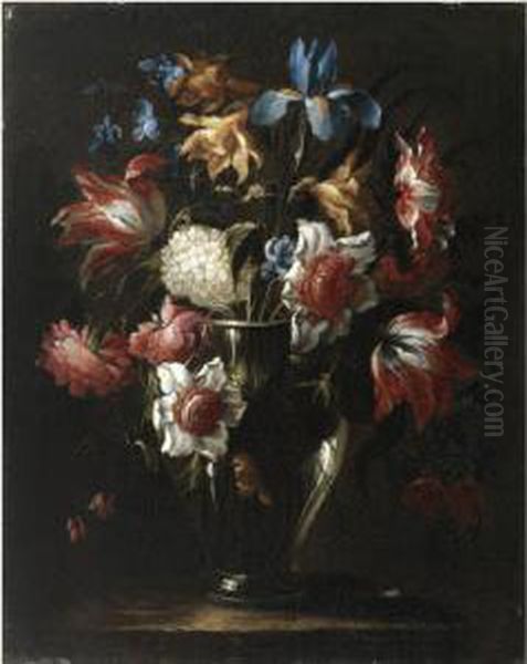 Still Life With Flowers In A 
Glass Vase, Including Blue Irises Andparrot Tulips, Arranged On A Stone 
Ledge Oil Painting by Juan De Arellano