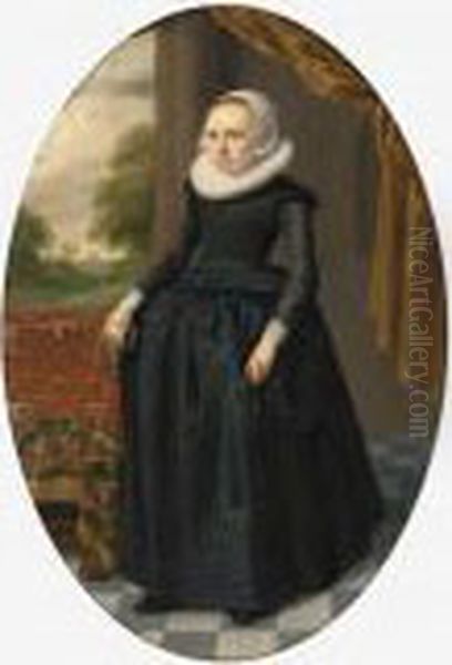 A Portrait Of A Lady, Standing 
Full-length, Wearing A Black Dress With Lace Collar And Bonnet, Holding 
Gloves, Near A Table Draped With A Persian Carpet Oil Painting by Thomas De Keyser