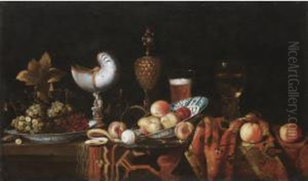 Still Life With Pears, Apples, 
Grapes In A Ceramic Bowl, A Partly Peeled Lemon, A Nautilus Cup, A 
Roemer And A Beer Glass, All Arranged On A Table Partly Draped With A 
Carpet Oil Painting by Johann Georg (also Hintz, Hainz, Heintz) Hinz