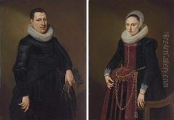 Portrait Of A Gentleman, 
Three-quarter Length, In A Black Coat With White Collar, Holding A Pair 
Of Gloves; And Portrait Of A Lady, Three-quarter Length, In A Black And 
Red Dress With Gold Chains, By A Chair Oil Painting by Cornelis van der Voort
