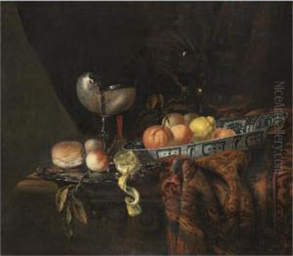 A Still Life With Oranges, 
Peaches And A Lemon In A Blue-and-white China Bowl, A Silver-gilt 
Nautilus Cup On A Silver Gilt Plate Together With A Lemon, A Bread Roll 
And A Knife, Together With A Roemer And A Wine Glass, All On A 
Partly-draped Table Oil Painting by Juriaen van Streeck