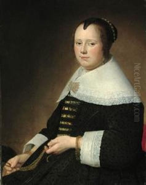 Potrait Of A Lady, 
Three-quarter-length, In A Black Dress With Gold Brocade, And A White 
Collar, Holding A Gold Chatelaine Oil Painting by Johannes Cornelisz. Verspronck