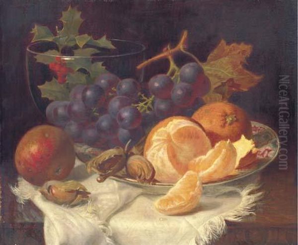 An Apple, Black Grapes, Two 
Oranges And Cob Nuts On Oriental Plate,with Holly In A Glass Vase, On A 
Wooden Table Oil Painting by Eloise Harriet Stannard