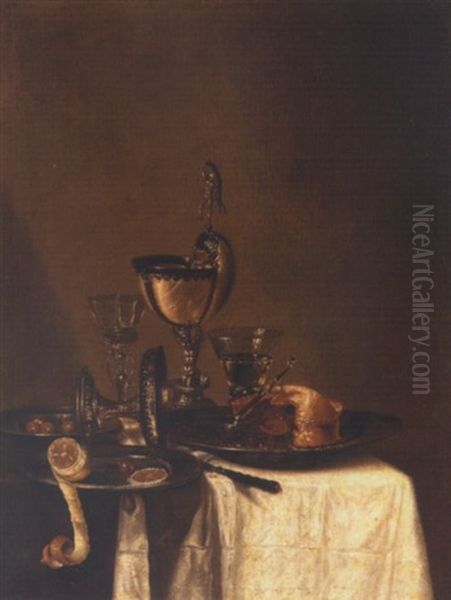 Still Life Of A Nautilus Cup, An Overturned Tazza, A Partially Eaten Pie In A Pewter Bowl And A Knife, Together With Two Wine Glasses, Olives And A Peeled Lemon, Upon A Draped Table Top Oil Painting by Willem Claesz Heda