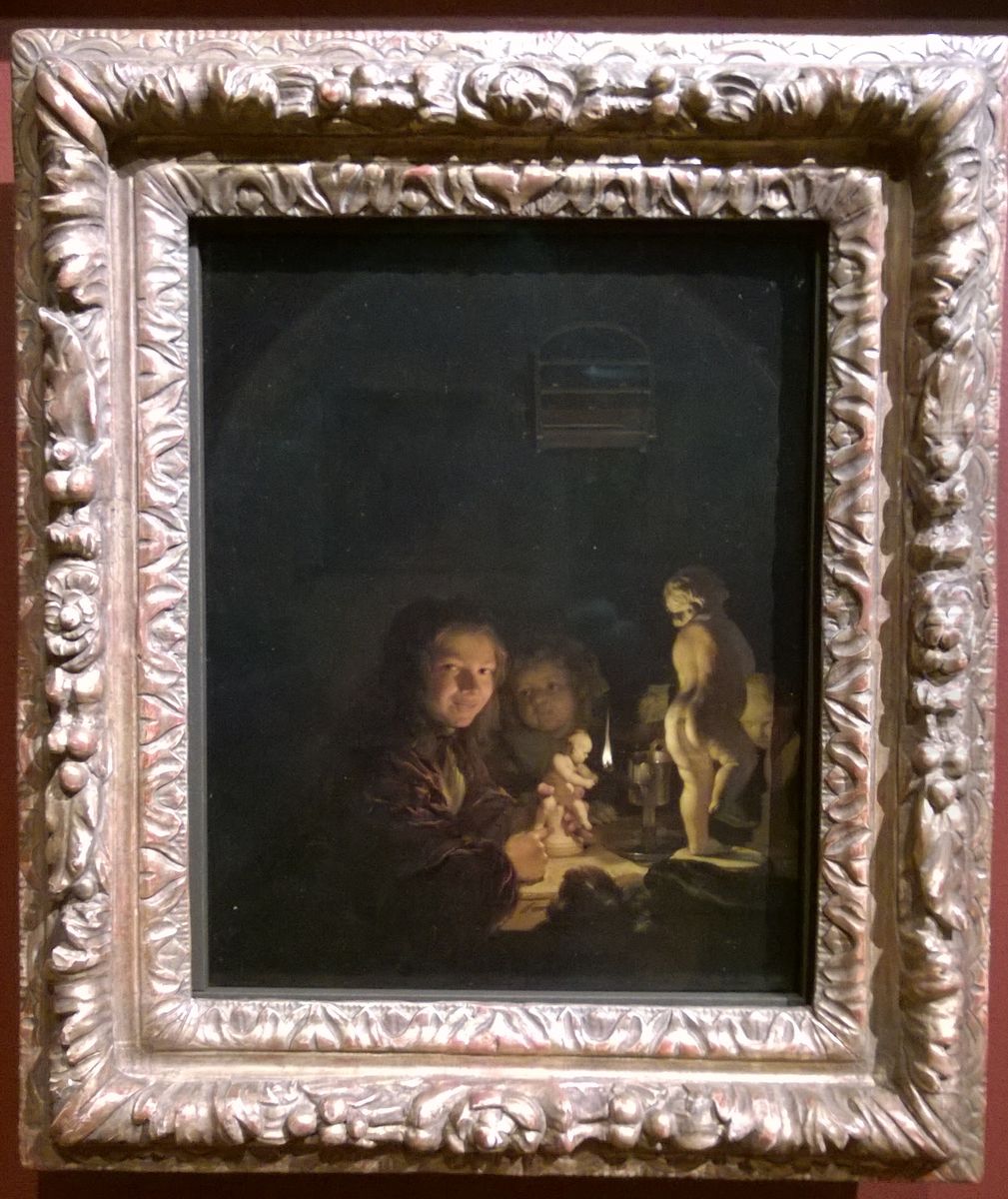 Two boys with plaster statuettes by the light of an oil lamp Oil Painting by Caspar Netscher